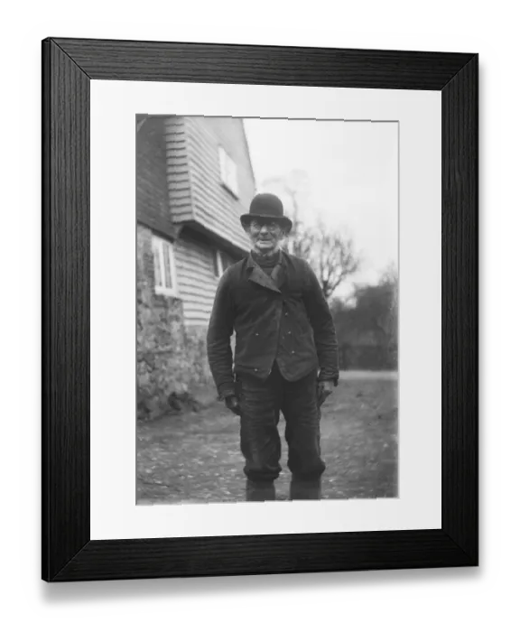 Framed Print : A man wearing a bowler hat and glasses MCF01_02_0009