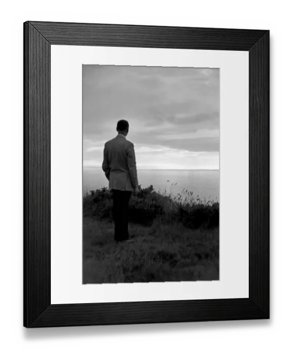 Framed Print : Man looking out to sea a002229