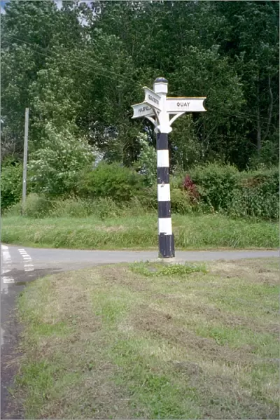 Signpost. Tapered hexagonal wooden signpost having 3 arms with lettering