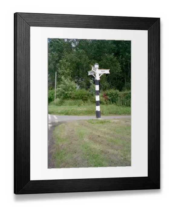 Framed Print : Signpost. Tapered hexagonal wooden signpost having 3 arms with lettering Framed Print : Signpost. Tapered hexagonal wooden signpost having 3 arms with lettering