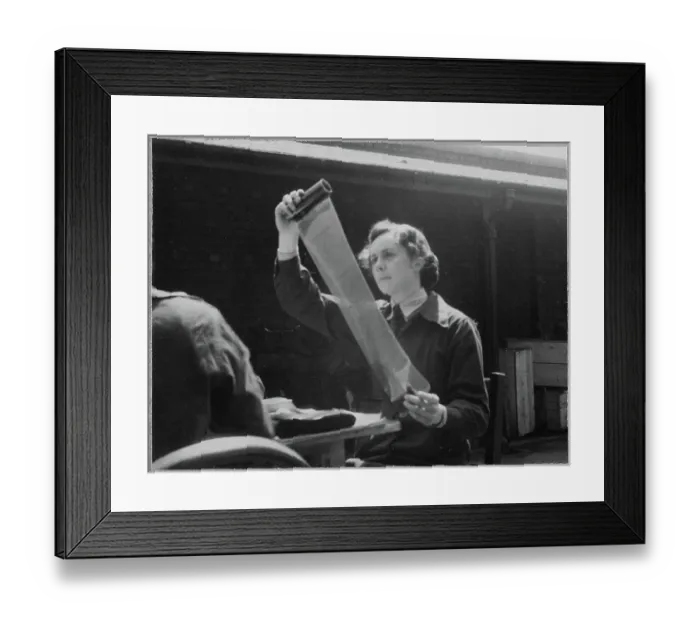 Framed Print : A Women's Auxiliary Air Force (WAAF) trainee examining a roll of photographic film chp01_07_01_058