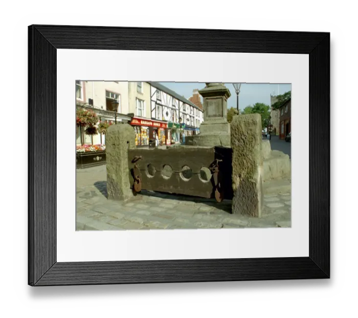 Framed Print : Stocks. Pair of stone pillars housing wooden stock beams with 2 pairs of leg-holes
