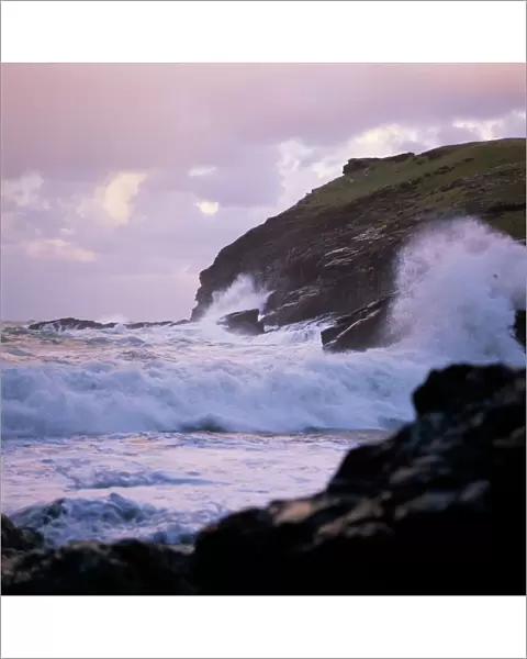 Waves crashing against the coastline K900459