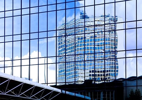 Blue skies reflected in glass tower blocks DP069225