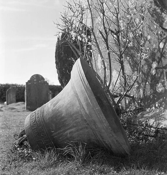 Church bell a082655. A church bell lying on its side in a churchyard in Somerset