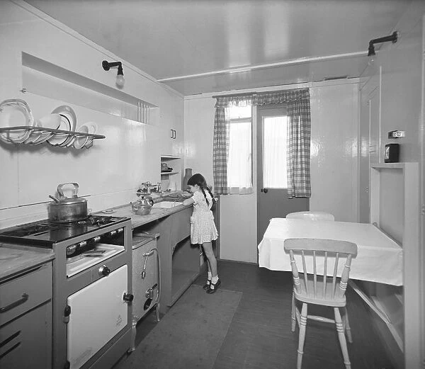 Girl in prefab kitchen P_H00049_007