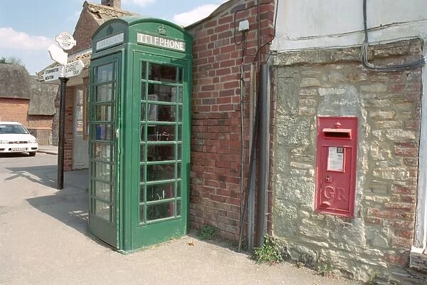 Green Telephone Box. A Dorset street scene of a telephone box, post box and signpost
