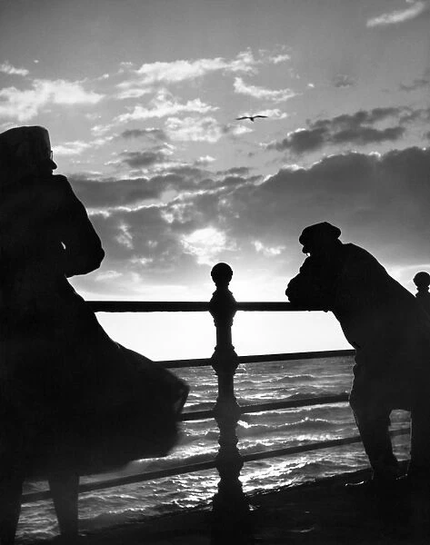 Man and woman looking out to sea OP04504