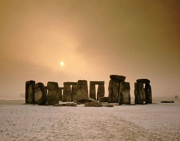 Stonehenge J850008. STONEHENGE, Wiltshire. Stones at sunset with snow in the foreground