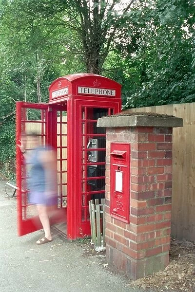 Telephone Kiosk. K6 Telephone box with blurred image of woman in doorway