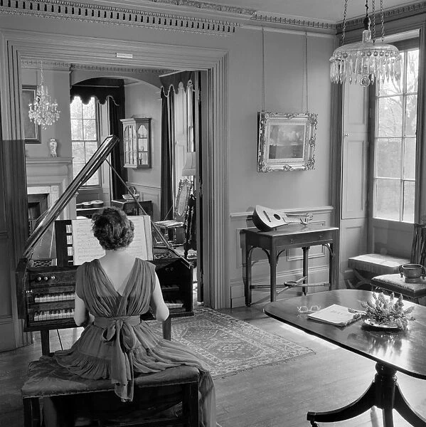 Woman playing harpsichord AA071907