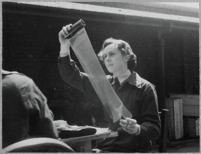 Framed Print : A Women's Auxiliary Air Force (WAAF) trainee examining a roll of photographic film chp01_07_01_058
