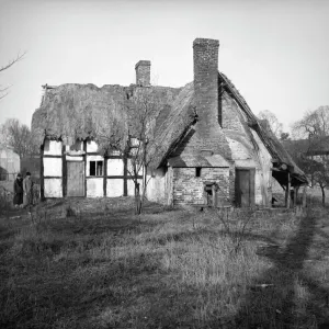 Print of Artists Cottage, a timber-framed house in disrepair