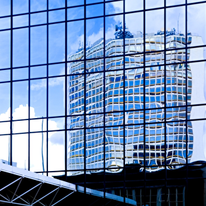 Blue skies reflected in glass tower blocks DP069225