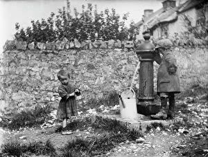 Edwardian Collection: Two children collecting water at a water pump MCF01_02_0182