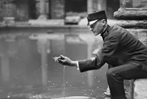 roman baths keeper handling tame goldfish bb45 02389