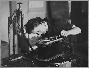Second World War Prints: A Women's Auxiliary Air Force (WAAF) trainee checking a roll of film chp01_07_01_054