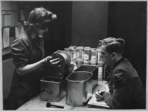 Second World War Prints: A Women's Auxiliary Air Force (WAAF) trainee handling a roll of photographic film chp01_07_01_059
