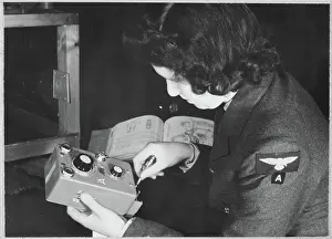 Second World War Prints: Women's Auxiliary Air Force (WAAF) trainee inspecting a T35 controller during training chp01_07_01_069