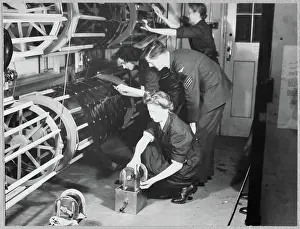 Second World War Prints: Women's Auxiliary Air Force (WAAF) trainees place photographic films on the drying drums chp01_07_01_060